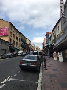 Street scene showing cars and stores on the border between Spain and France